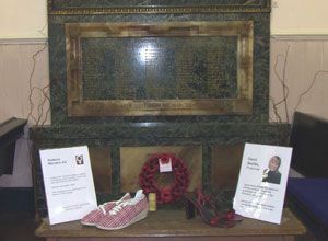 The shoes from Shetland Women's Aid and Carol Smilie in front of the war memorial in South Leith Parish Church