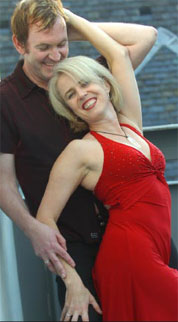 Lloyd spinning Carol Ann in a red knee length dress