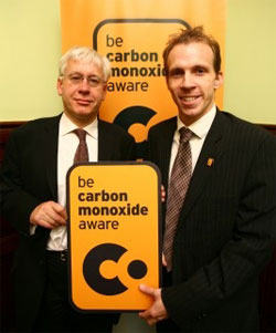 Mark Lazarowicz displaying the new carbon monoxide warning logo with COCAA Chair Dan Caesar 