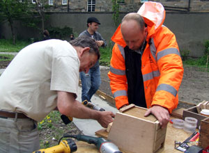 Julian drilling into a self assemble bat box supervised by a Bat Conservation Trust volunteer 