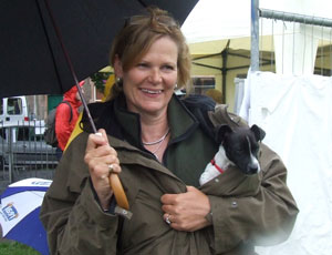 Woman holding a wee terrier puppy inside her parka