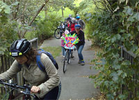Supporters of Greener Leith pushing their bikes up the path on their way to join in Portobello's car free day