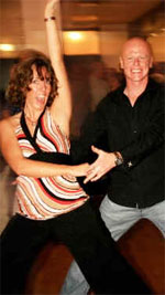 Lindsay in dance pose with her arm high in the air