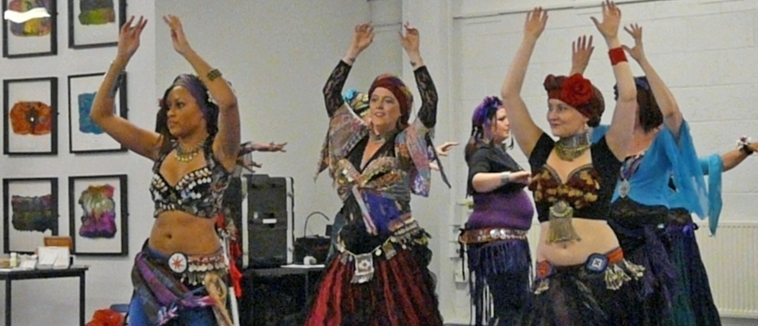 Two rows of women tribal belly dancing
