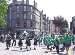 The Sunshine on Leith Pipes and Salsa Band marching up Links Gardens