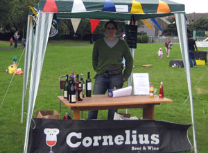 Woman in jeans with wine bottles on a table under a gazebo