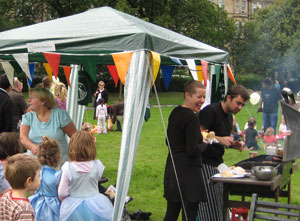 Renroc staff enjoy a joke over the BBQ while children wait for the food to be ready