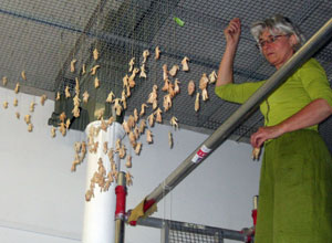 Jane Frere in green cotton on the scaffolding hanging the smaller figures