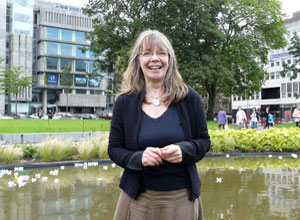 Claire MacLeod smiles behind her earrings at the Eero & Riley stall