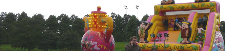 Amber and shocking pink teapot and inflatable slides with Fred Flintstone and Barney Rubble figures