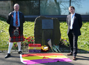 Colin stands to the left in full tartan costume