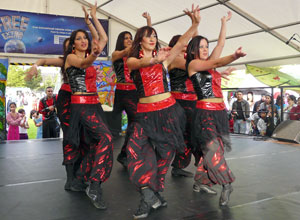 Desi Bravehearts in close formation in red and black tunics with baggy black pants