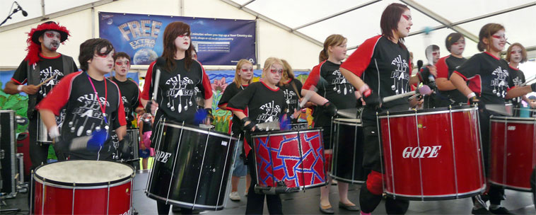Duncan Place Resource Centre, Leith's Pulse of the Place drummers in black and red teeshirts drumming