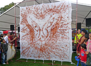 Painting of a lion's head in red on a white canvas around 3 metres squared
