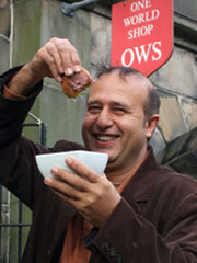 Nasser Abufarha with his olive oil dipped in bread outside the One World Shop