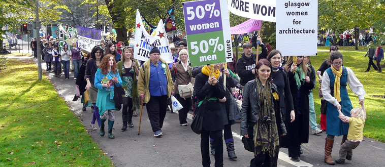 Marchers with lilac and green banners entering Middle Meadow Walk
