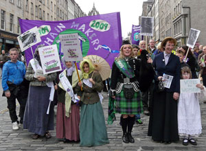 Piper with women and children in period costume