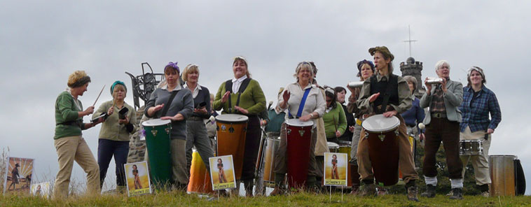 Women dressed as the World War 2 Land Army playing drums and whistles welcoming people to Calton Hill