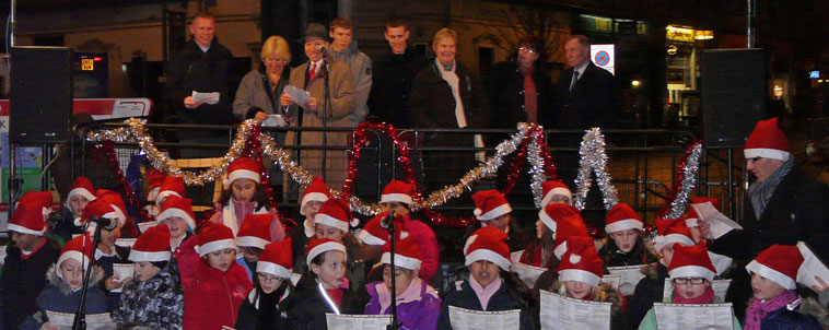 John Hughes, Margo Macdonald,  Gordon Munro, Marjorie Thomas, Dierdre Brock and Tom Farmet watch on as Lorne Primary pupils in santa hats sing