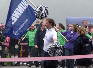 Man in white tee shirt with black and white pom poms