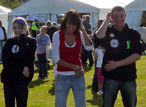 Three laughing young people doing the mashed potato