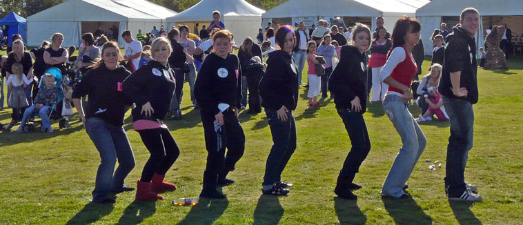 Seven young people from the Intergenerational Project dancing ina line