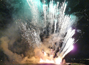 The effigies surrounded by white rockets with tourquoise and orange smoke