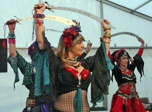 Three members of Twisted Tails with swords raised above their heads