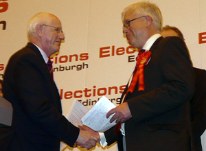 Retiring Returning Officer, City of Edinburgh Council Chief Executive, Tom Aitchison  shakes Mark Lazarowicz's hand