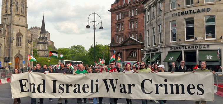 Demonstrators outside the Israeli owned Caledonian Hotel with banner: "End Israeli War Crimes