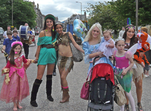 Young women with small girls all dressed up as princesses or Pocahontas