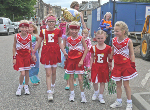 Five girls in red and white cheerleaders costume with stars and stripes