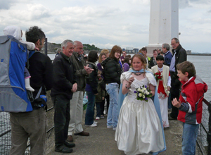 Smiling photographers watch as Courtney and her Royal Party pass by