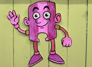 Smiling waving figure, coloured in pink stripes with blood shot eyes