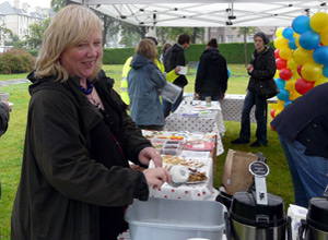 Woman in a parka jacket washing a tea cup