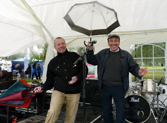 Two men with umbrellas. Dancing.