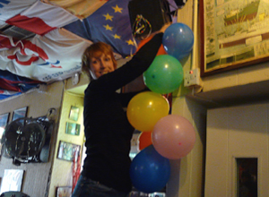 Woman hanging up balloons