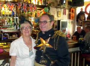 Woman in white two piece outfit and man in black uniform