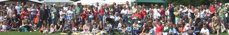 Leithers watching performers at the main stage area on Leith Links in front of the United Churches of Leith marquee