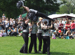 Young women raise a majorette aloft on her back