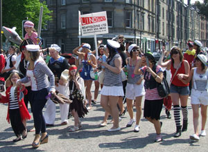 Women and children in white and blue sailor outfits