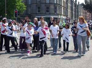 Young people in jeans wearing white t-shirts with the cerise Open All Hours logo