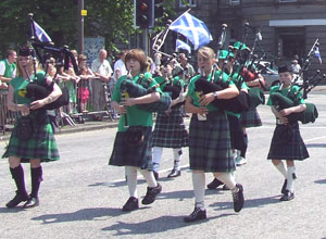 Louise Millington leads young pipers with Saltires blowing back from their pipes